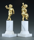 Picture of CA0317 Delightful pair of bronze dancing putti on white marble columns